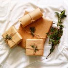 Christmas presents in brown paper — Stock Photo