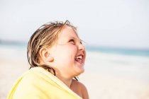 Toddler laughing in towel — Stock Photo
