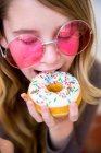 Крупним планом дівчина їсть пончик — стокове фото