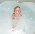 Купання дитини в ванні з водою — стокове фото