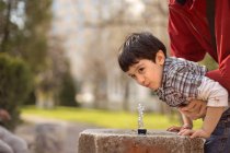 Boy drinking water — Stock Photo