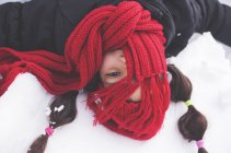 Girl with red scarf covering face — Stock Photo