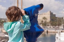 Boy looking through binoculars — Stock Photo