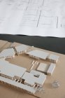 Close-up of architectural plans and model — Stock Photo