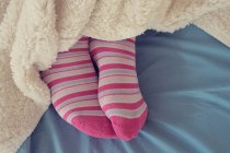 Woman feet in pink socks — Stock Photo