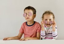 Boy with girl wearing sunglasses — Stock Photo