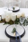 Table setting with candle centerpiece — Stock Photo