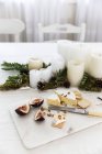 Cheese platter next to a candle centerpiece — Stock Photo