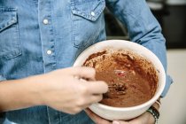 Woman mixing chocolate cake batter — Stock Photo