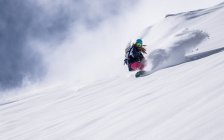 Girl Snowboarding in fresh powder snow — Stock Photo