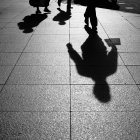 Shadows and Silhouettes of people on street — Stock Photo
