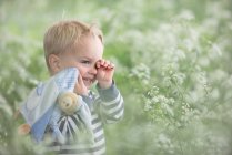 Tired toddler standing in a field — Stock Photo