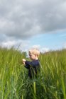 Мальчик, стоящий в поле — стоковое фото