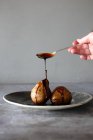 Baked Pears being drizzled with caramel — Stock Photo