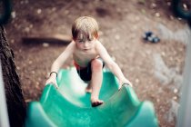 Toddler climbing up  slide — Stock Photo