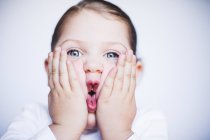Girl squashing her cheeks — Stock Photo