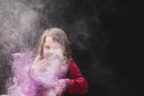 Girl playing in dust — Stock Photo