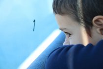 Boy looking out of window — Stock Photo