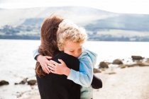 Mother hugging son — Stock Photo