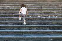 Girl walking up stairs — Stock Photo