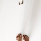 Woman feet and cat paws — Stock Photo