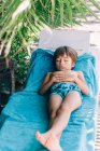 Boy sleeping on sun lounger — Stock Photo