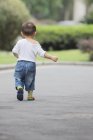 Little boy walking outdoors — Stock Photo
