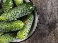 Cucmbers on wooden surface — Stock Photo