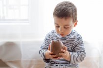 Boy eating chocolate easter egg — Stock Photo