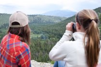 Woman and girl looking through binoculars — Stock Photo
