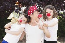 Mother with son and daughter dressed as clowns — Stock Photo