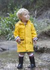 Toddler boy standing in creek — Stock Photo
