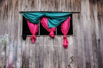 Curtains in window of wooden building, Malaysia — Stock Photo