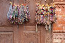 Closeup view of colorful bracelets hanging on door — Stock Photo
