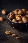 Closeup view of walnuts in bowl on table — Stock Photo