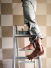 Close-up partial view of Man standing on ladder — Stock Photo