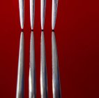 Close up image of two forks against red background — Stock Photo