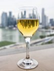 Singapore skyline reflected in glass of wine — Stock Photo