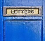 Close-up view of blue metal domestic letterbox — Stock Photo