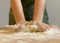 Close-up view of Woman hands kneading dough — Stock Photo