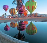 Hot Air Balloons reflected in pond at Lake Havasu Balloon Festival, Beachcomber Boulevard, Arizona, USA — Stock Photo