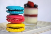 Closeup of colorful macaroons desert on white plate — Stock Photo