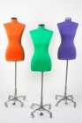 Three colorful mannequins in a studio against white background — Stock Photo