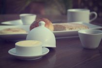 Tee, Brot und Butter zum Frühstück über dem Tisch — Stockfoto