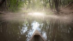 Scenic view of kayak on a river in the fog — Stock Photo