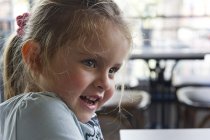 Portrait de fille souriante regardant latéralement — Photo de stock