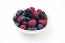 Fresh summer berries in bowl on white background — Stock Photo