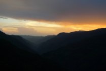 Vista panorámica de la hermosa puesta de sol detrás de las colinas - foto de stock