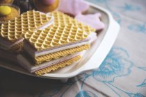 Tasty cupcakes and wafers on tray, closeup — Stock Photo