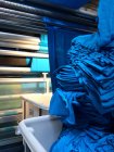 Closeup view of fabric mill with blue clothes — Stock Photo